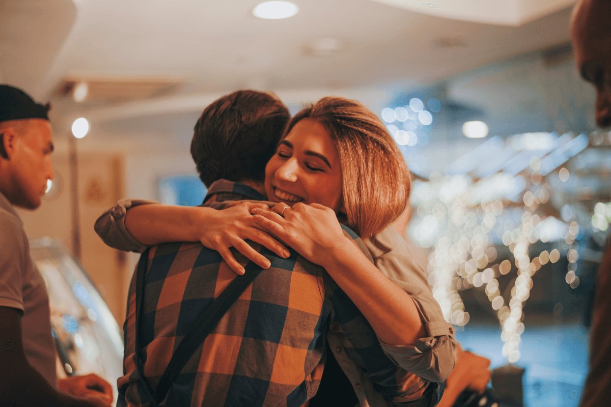Woman hugging man, showing that touching and displays of affection is acceptable and common in Western cultures, but not so much in Eastern cultures.