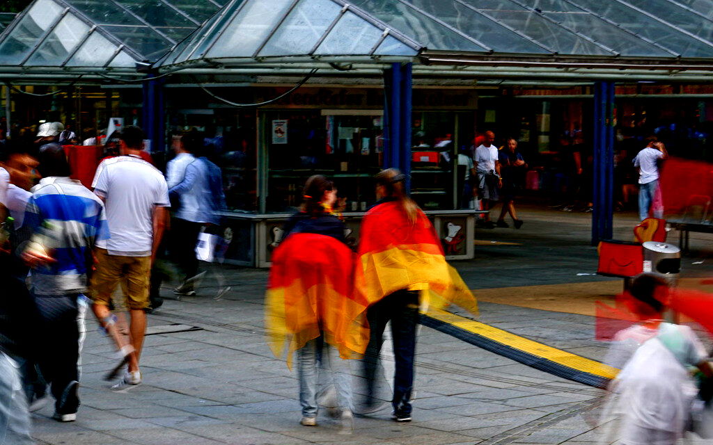 Two people draped in German flag