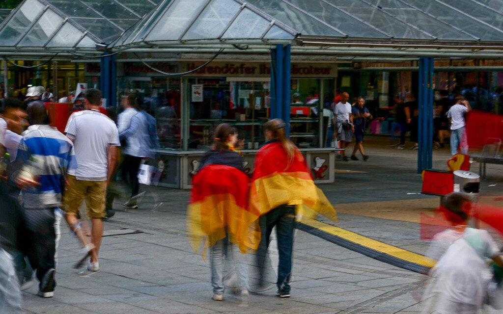 Two people draped in German flag
