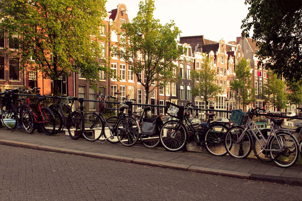 Rows of bicycles near the canal-side railing in Amsterdam